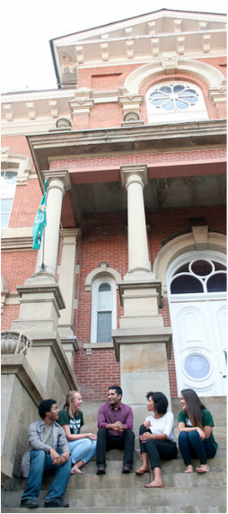 Athens courthouse with 5 individuals sitting on the steps talking with one another